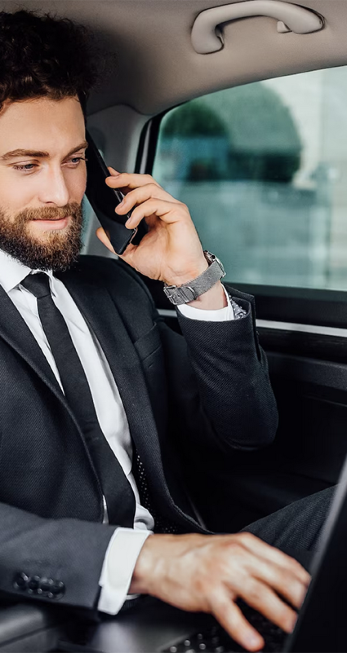 man-working-with-his-laptop-a-car